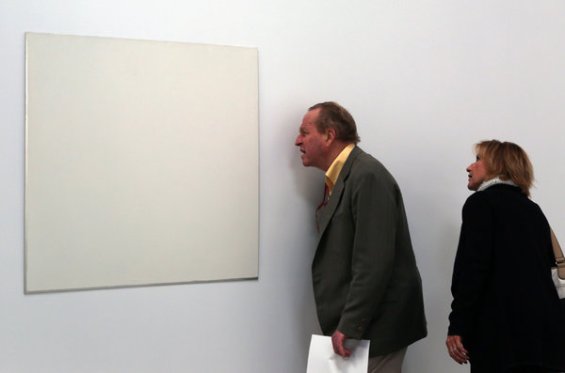 Visitors study untitled 1973 in the Robert Ryman exhibition
